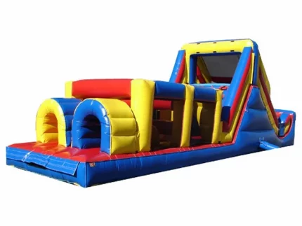 Large inflatable obstacle course with tunnels, climbing wall, and slide in bright red, yellow, and blue. Perfect for events. Buy this fun course online today!