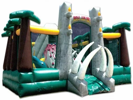 Dinosaur-themed bounce house with palm trees, tusk entrance, and vibrant colors. Perfect for kids' parties. Buy online now for affordable prices!
