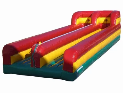 Inflatable dual-lane bungee run in red, yellow, and green. Perfect for events and competitions. Buy this fun bounce house online today!