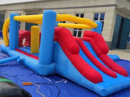 Dual-slide inflatable obstacle course bounce house, perfect for kids' parties and events. Durable, colorful, and fun. Buy online for affordable entertainment!